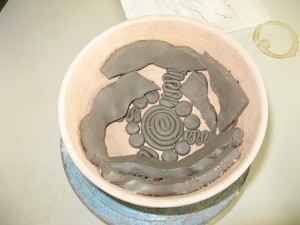 press mould being filled with clay